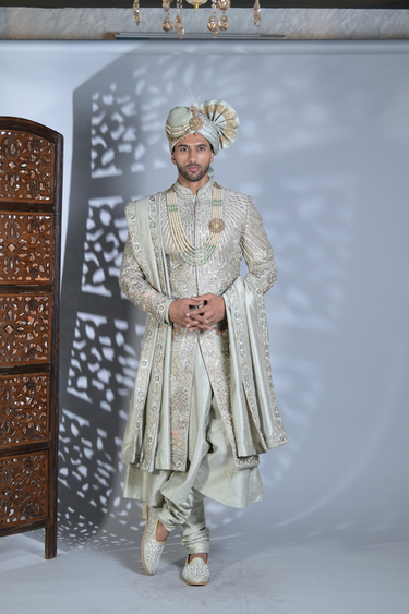 Green heavy embrorided sherwani set with matching churidar